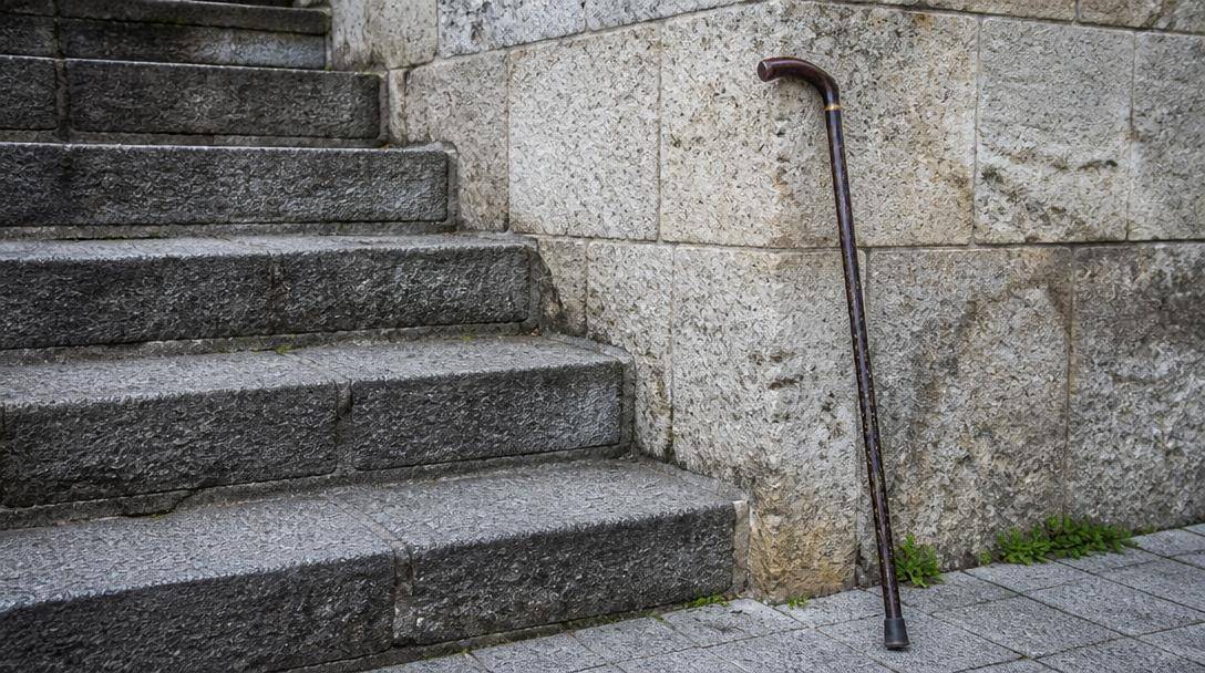 Professionista sanitario parla con una persona anziana delle difficoltà nelle attività quotidiane.